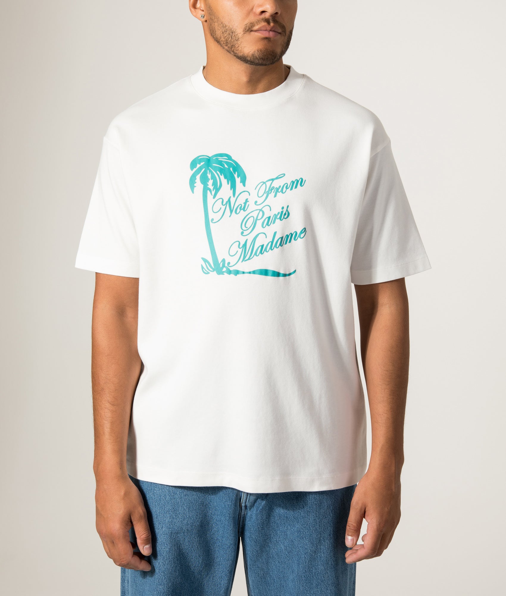 Drôle de Monsieur Palm Slogan T-Shirt in Off White at EQVVS Menswear. Model front shot.