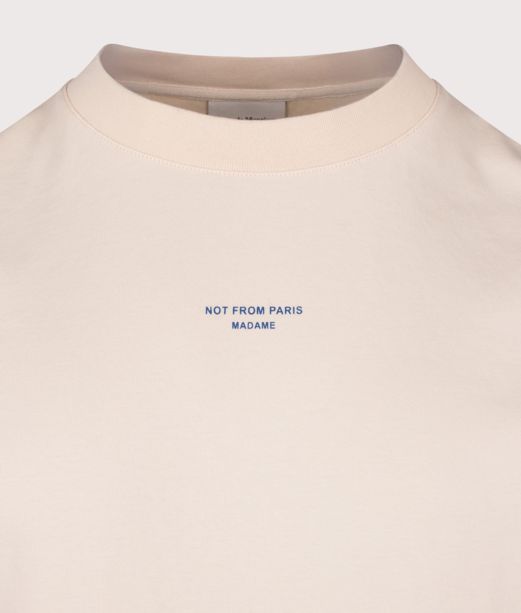 Drôle de Monsieur Relaxed Fit Classic Slogan T-Shirt in Sand at EQVVS Menswear. Detail shot.