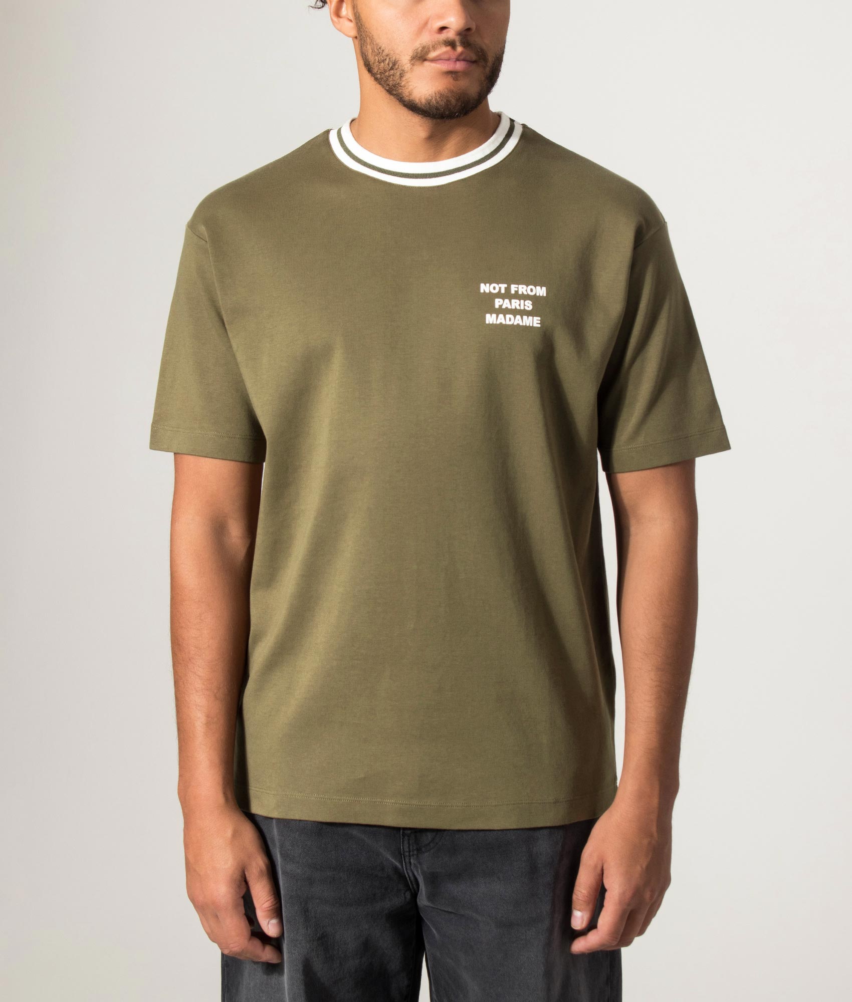 Drôle de Monsieur Sport Slogan T-shirt in Khaki at EQVVS Menswear. Model front shot.