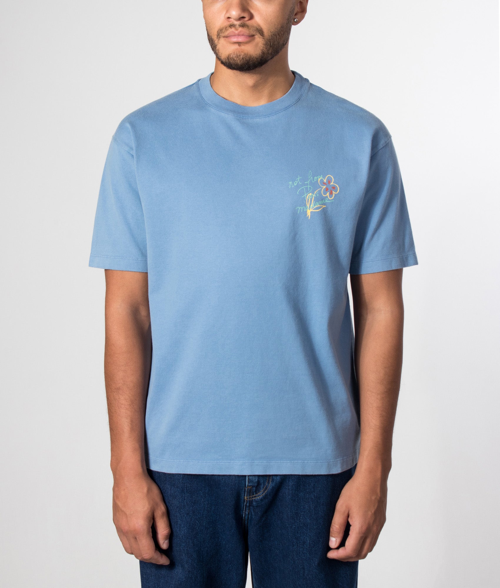 Drôle de Monsieur Relaxed fit Esquisse Slogan T-shirt in Light Blue at EQVVS Menswear. Model front shot.
