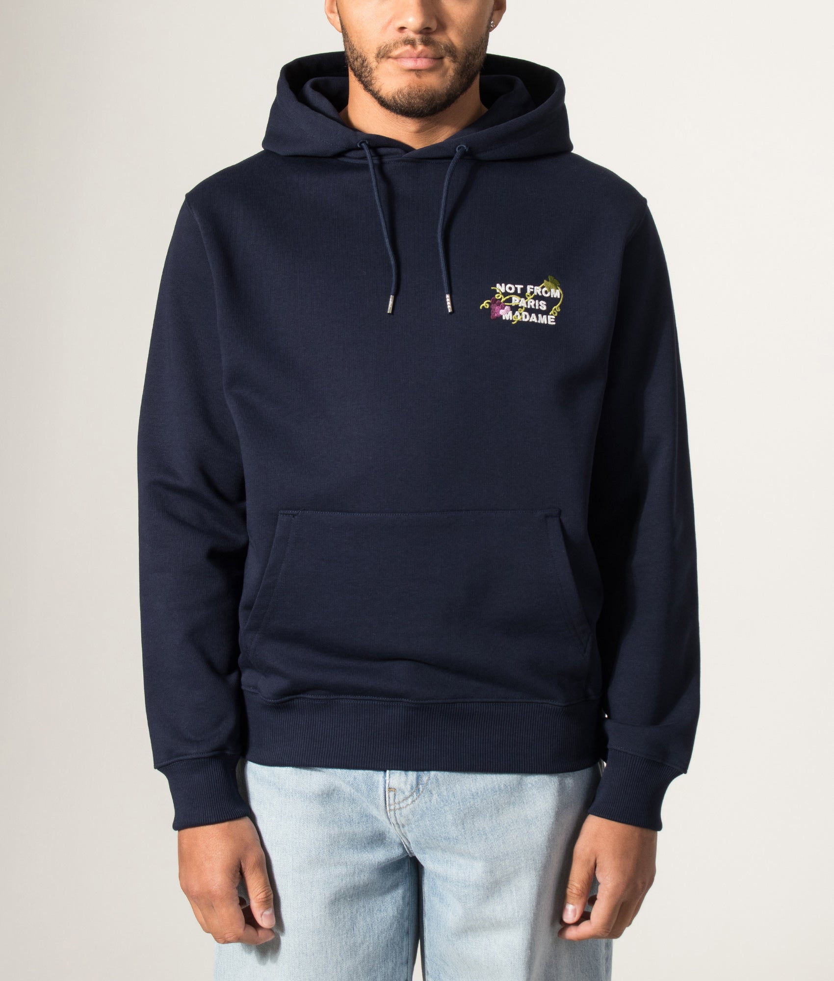 Drôle de Monsieur Relaxed Fit Vine Embroidered Slogan Hoodie in Navy at EQVVS Menswear. Model front shot.