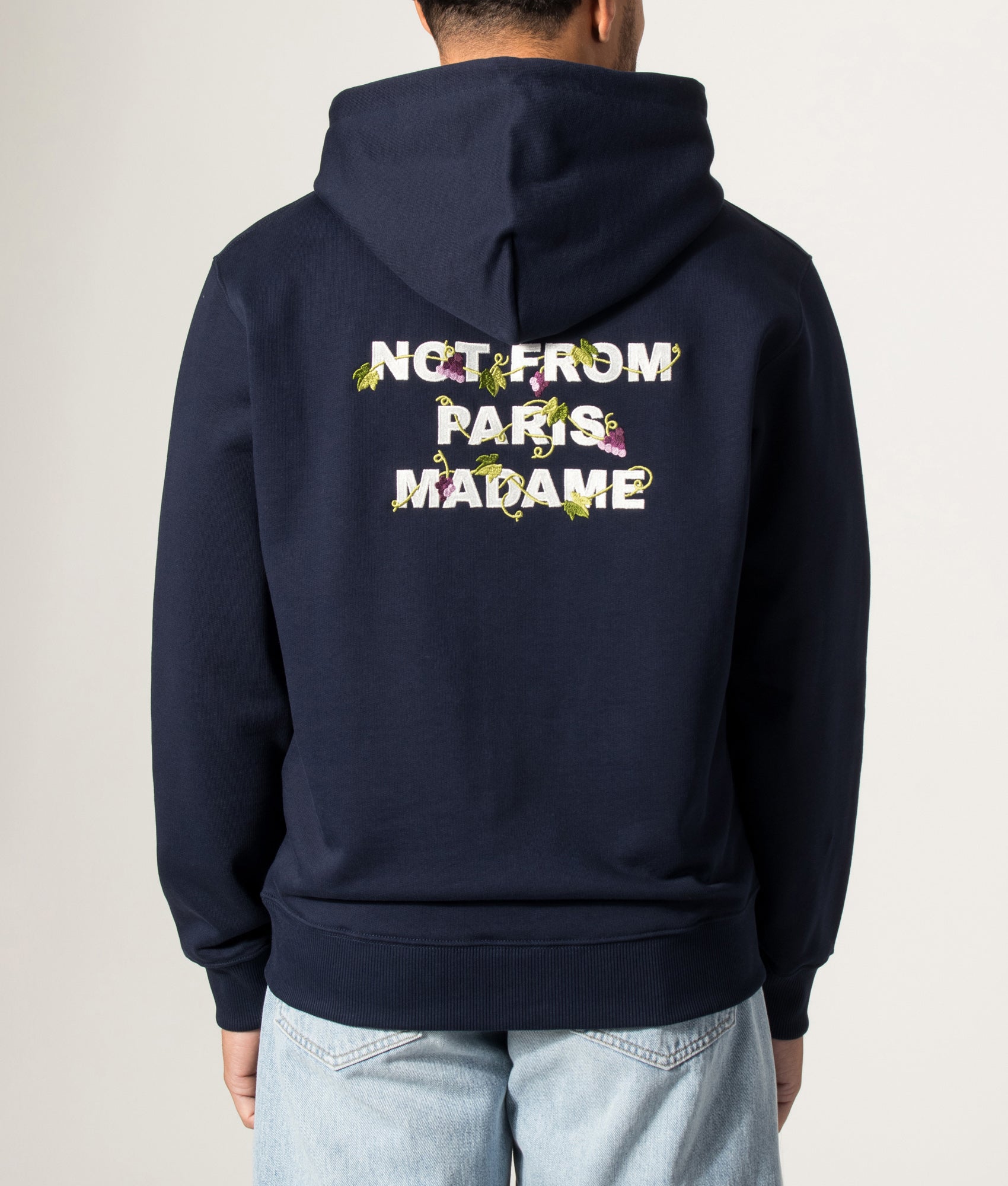 Drôle de Monsieur Relaxed Fit Vine Embroidered Slogan Hoodie in Navy at EQVVS Menswear. Model back shot.