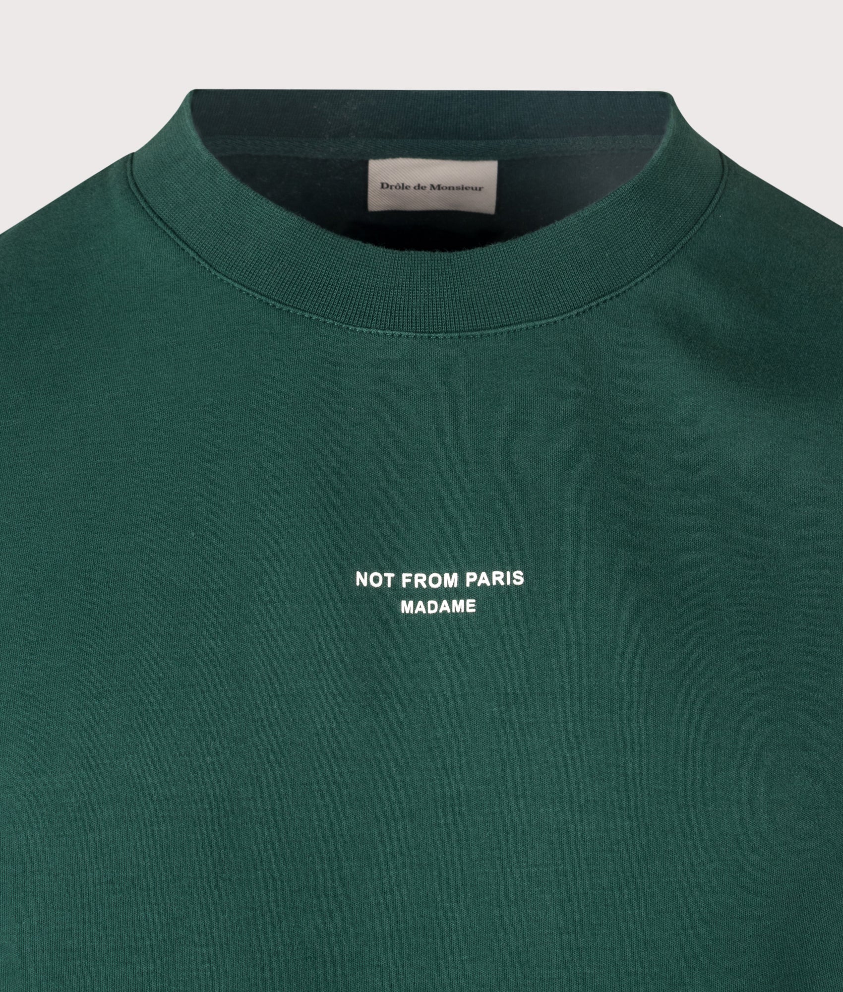 Drôle de Monsieur Relaxed Fit Classic Slogan T-shirt in Dark Green at EQVVS Menswear. Detail shot.