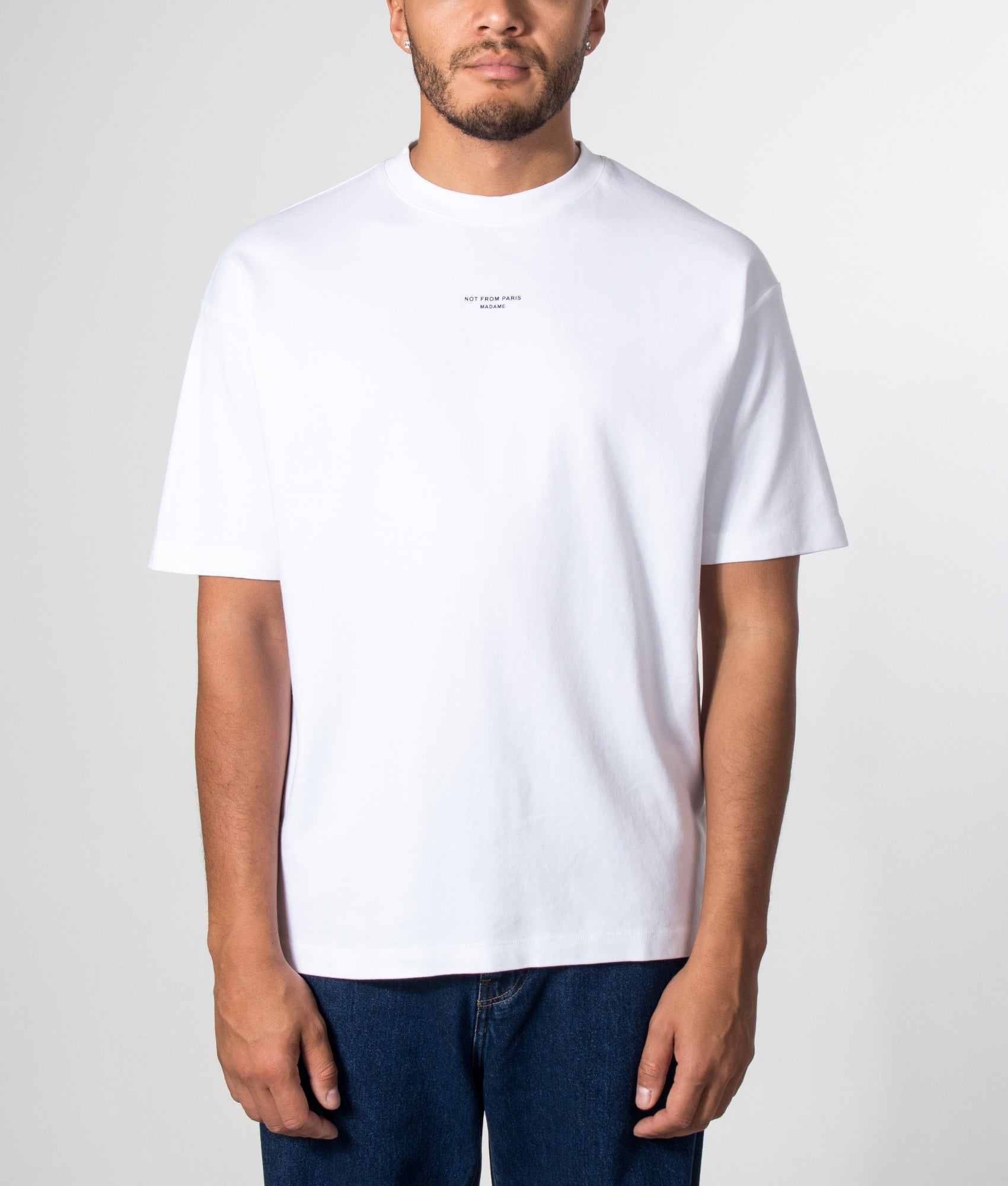 Drôle de Monsieur Relaxed Fit Classic Slogan T-shirt in Optic White at EQVVS Menswear. Model front shot.