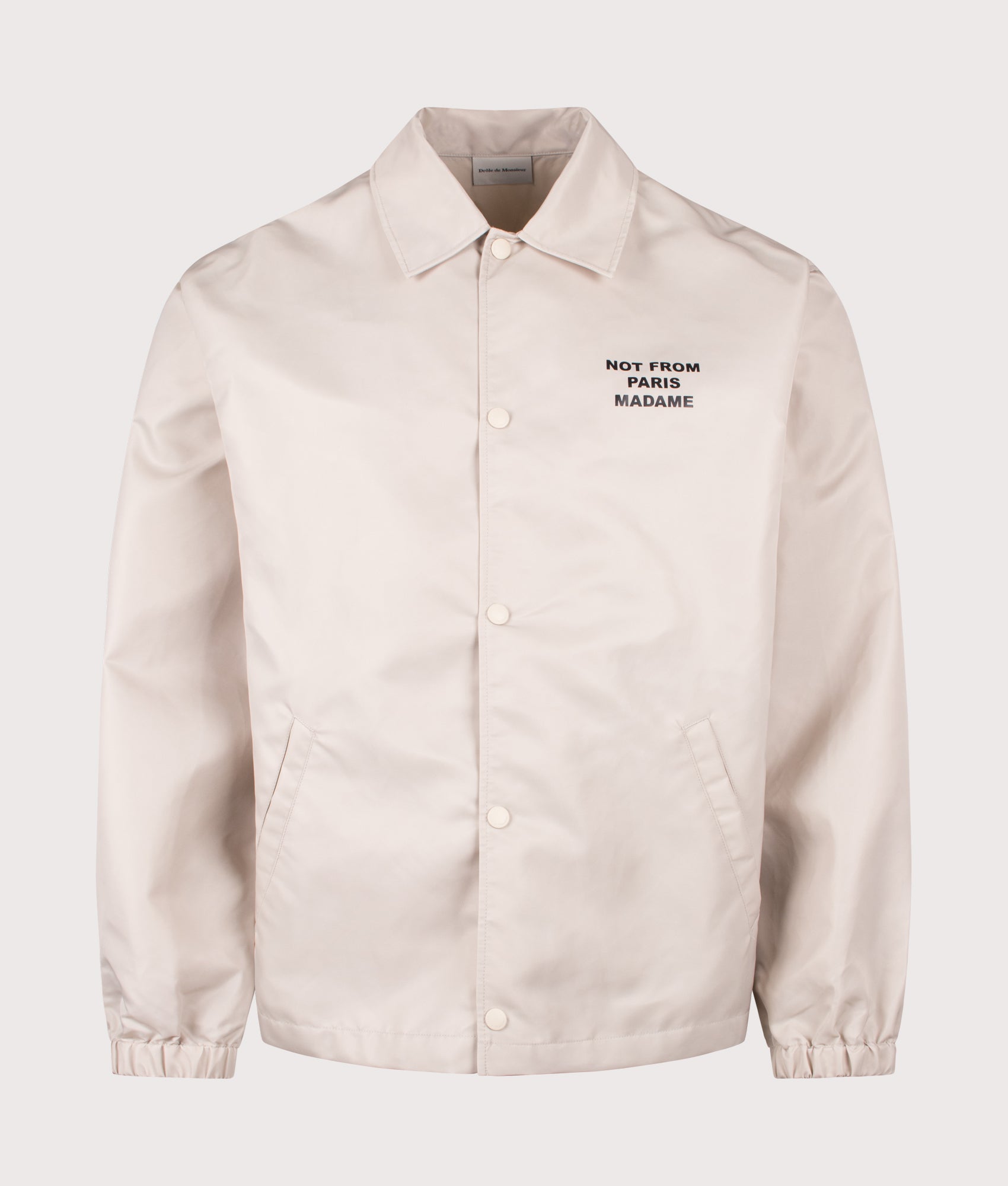 Slogan Jacket in Mastic by Drôle de Monsieur. Shot by EQVVS. Front shot.