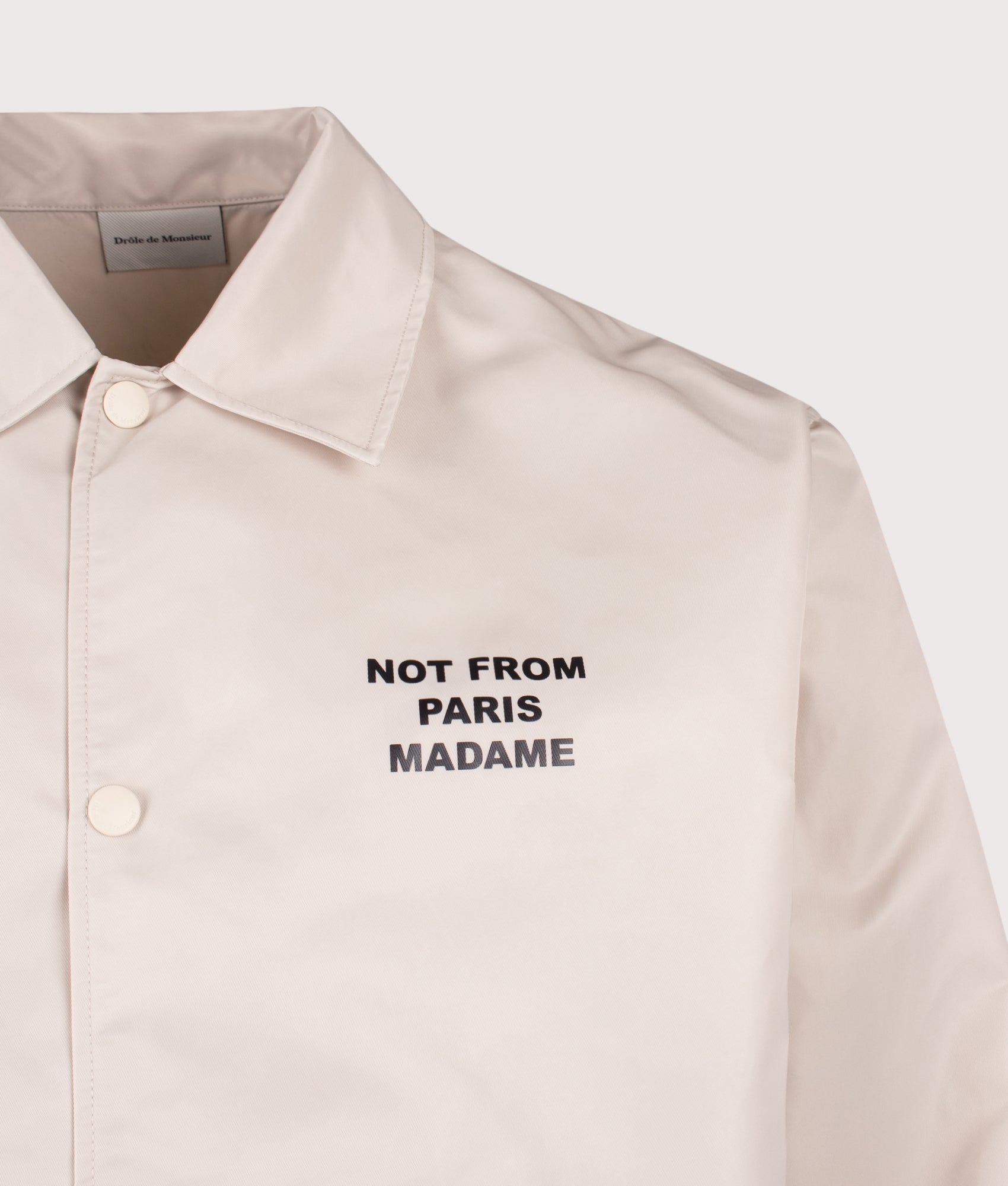 Slogan Jacket in Mastic by Drôle de Monsieur. Shot by EQVVS. Detail shot.
