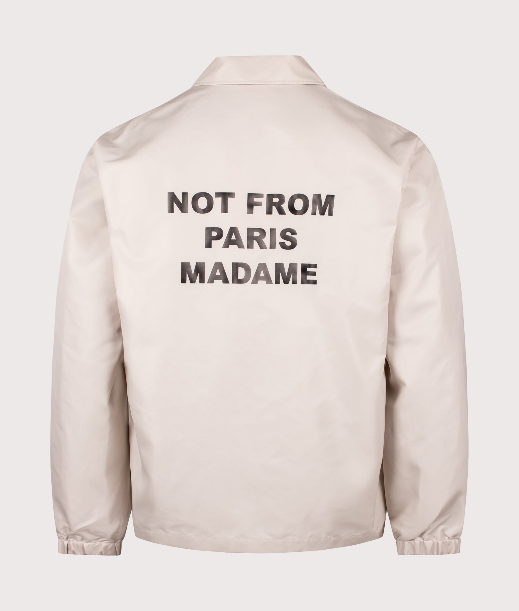 Slogan Jacket in Mastic by Drôle de Monsieur. Shot by EQVVS. Back shot.
