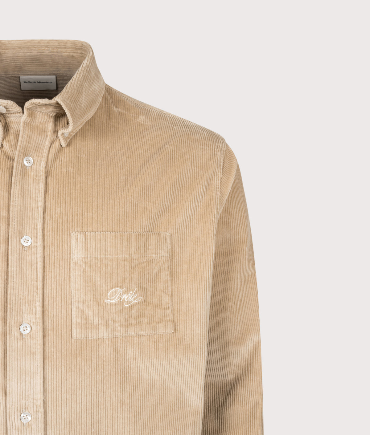Drôle de Monsieur Relaxed Fit Corduroy Shirt in Beige at EQVVS Menswear. Detail shot.