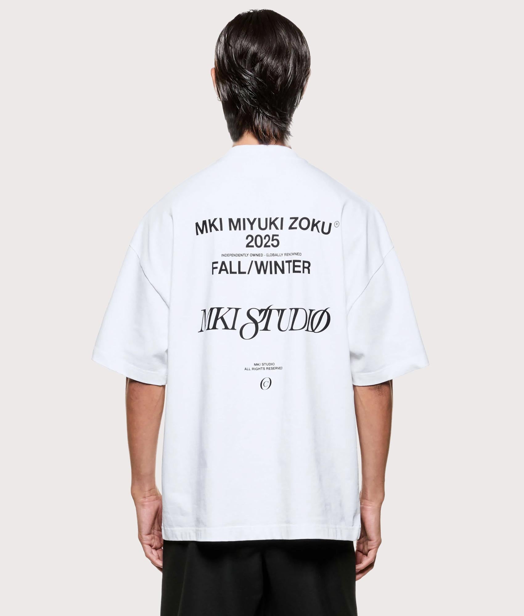 MKI MIYUKI ZOKU Script T shirt in White at EQVVS Menswear. Model back shot.