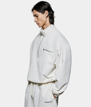 Seersucker Quarter Zip Sweatshirt. Shot by EQVVS. Front model angled shot.