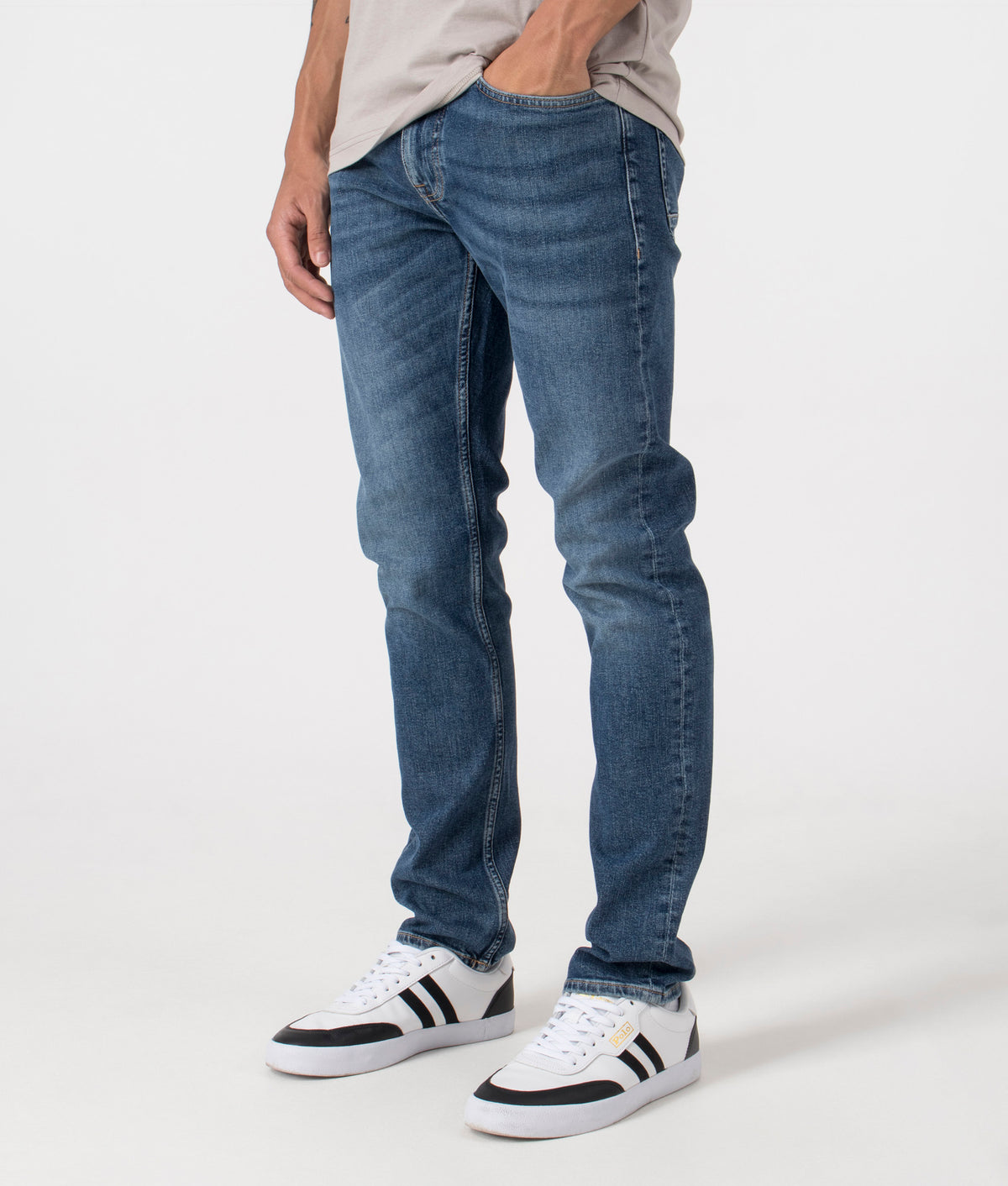 BOSS Slim Fit Delaware Comfort Stretch Jeans in Dark Blue. Side angle shot at EQVVS.