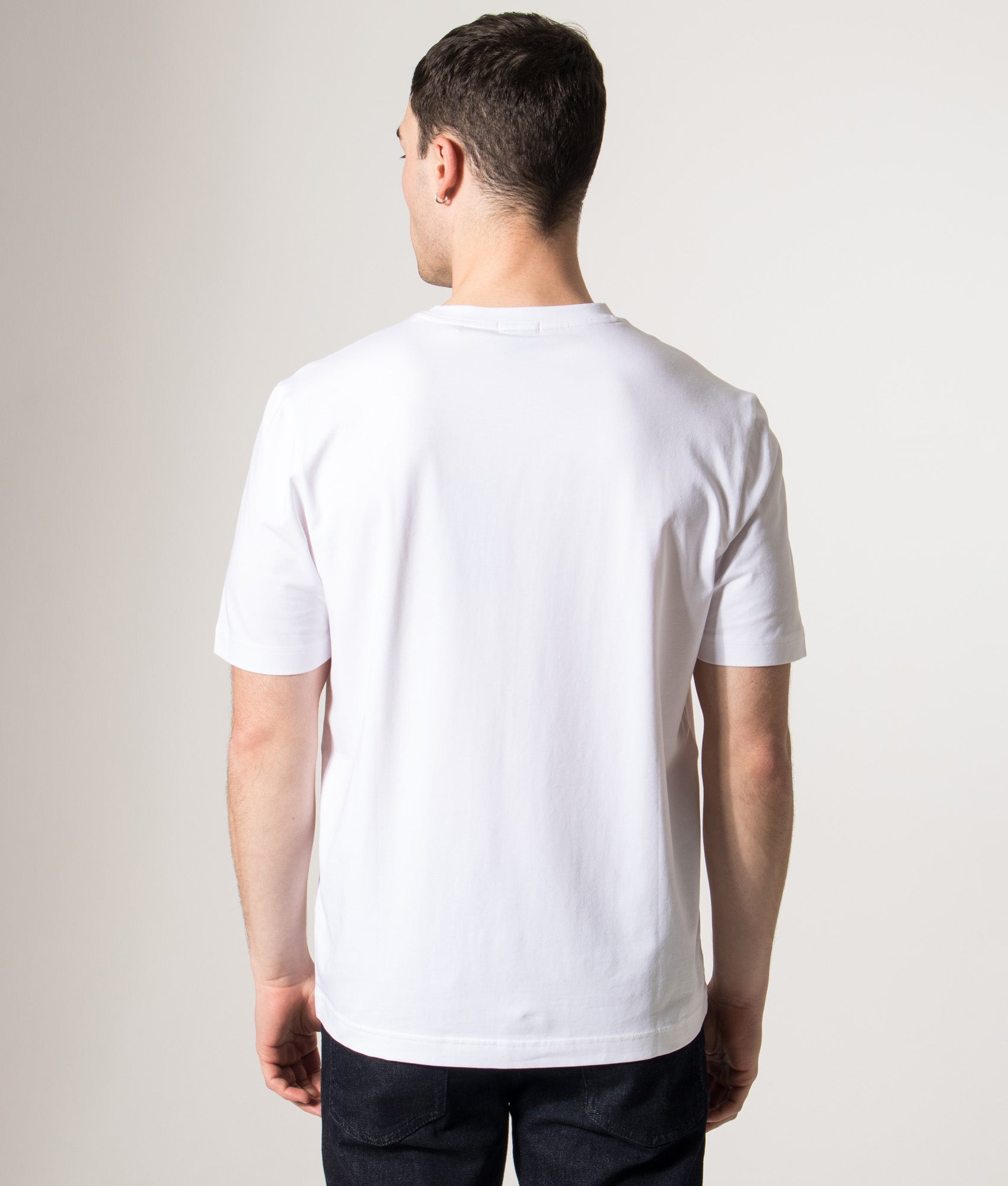 BOSS Relaxed Fit T-Chup T-Shirt in White at EQVVS Menswear. Model back shot.