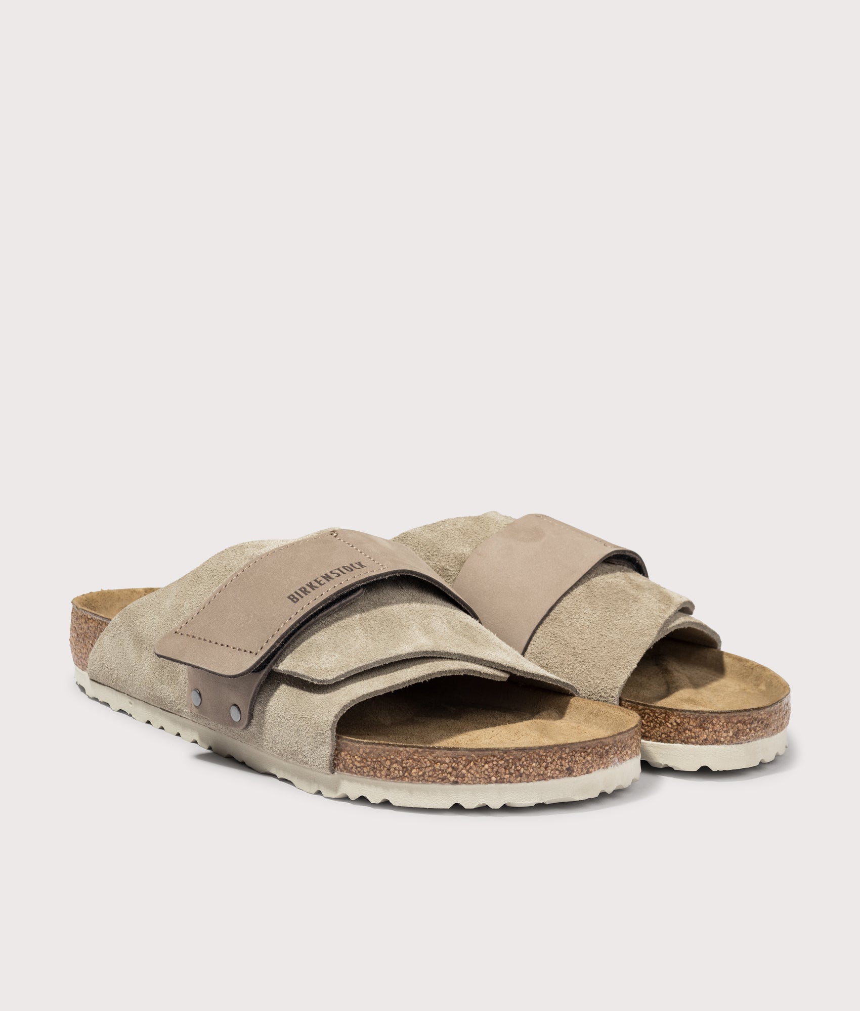 BIRKENSTOCK Kyoto Nubuck-Suede Leather Sandals in Taupe at EQVVS Menswear. Angled front shot.
