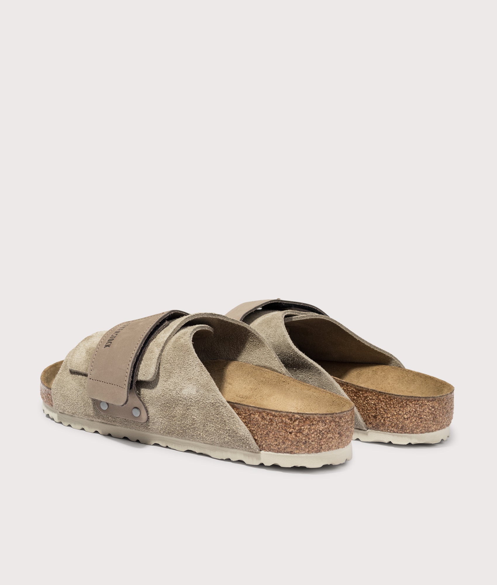 BIRKENSTOCK Kyoto Nubuck-Suede Leather Sandals in Taupe at EQVVS Menswear. Angled back shot.