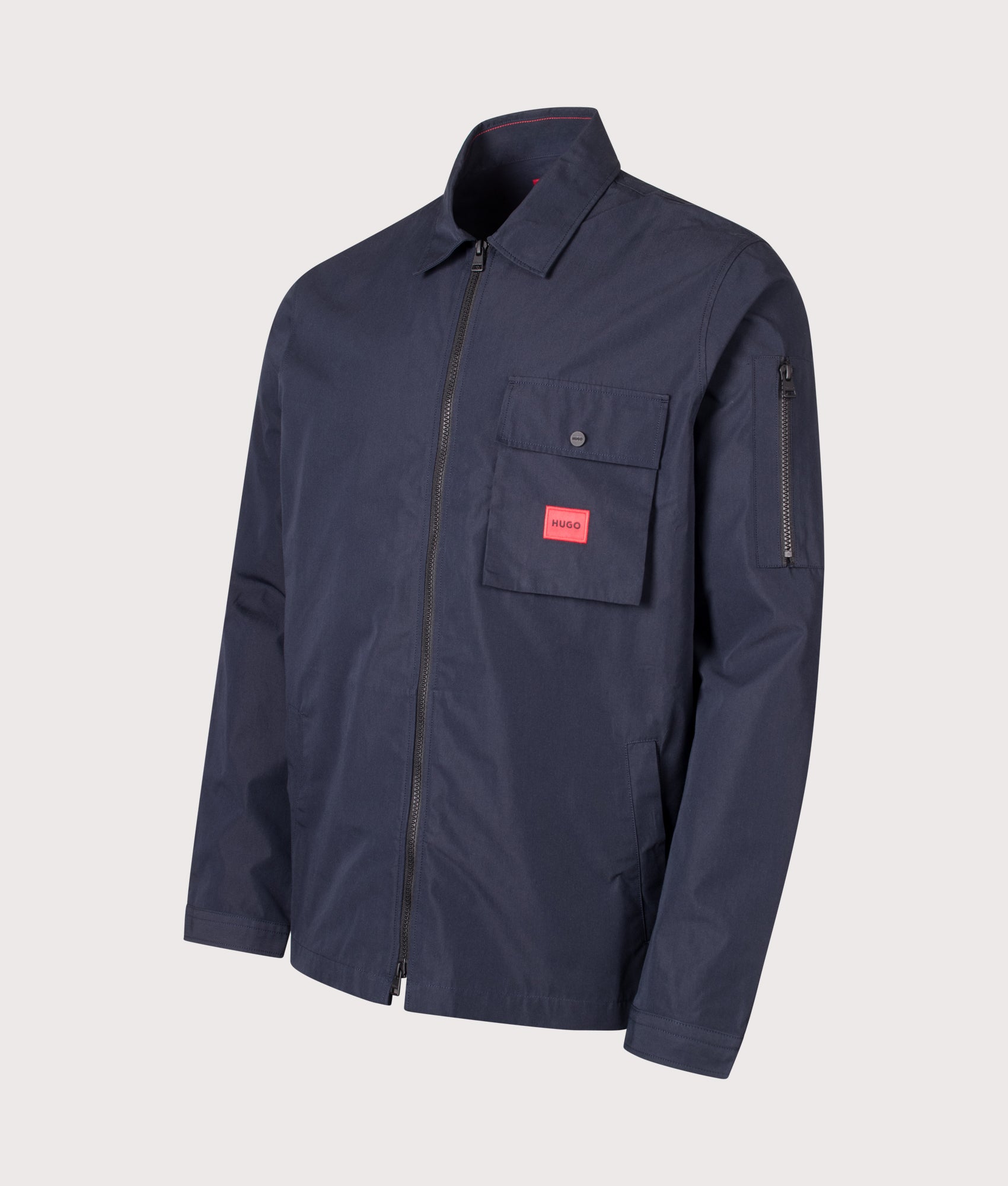 HUGO Relaxed Fit Emmond Zip Through Overshirt in Dark Blue at EQVVS Menswear. Angled front shot.