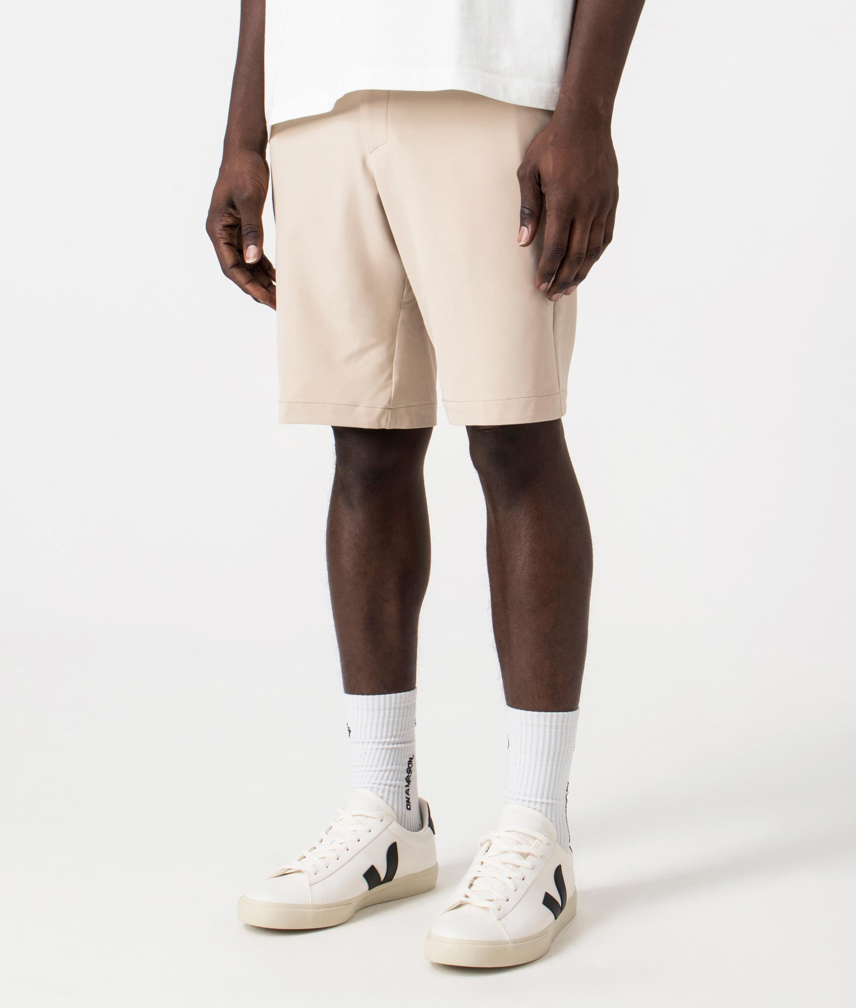 BOSS Slim Fit Commuter Chinos in Medium beige. Side angle shot at EQVVS.