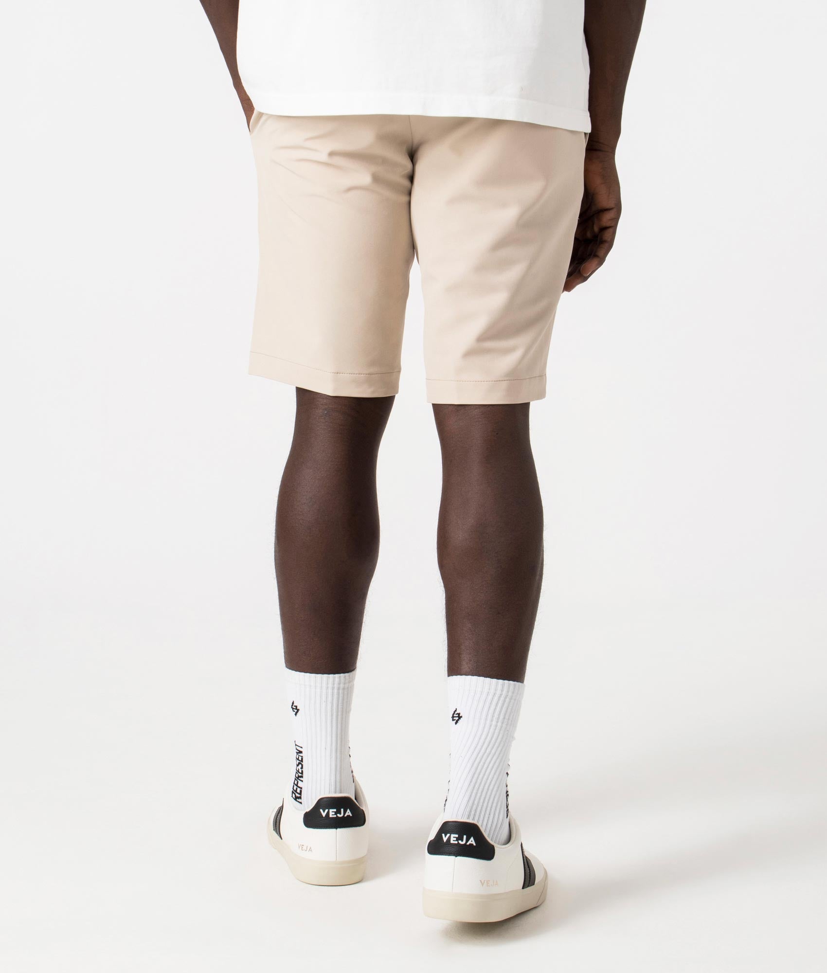 BOSS Slim Fit Commuter Chinos in Medium beige. Back angle shot at EQVVS.
