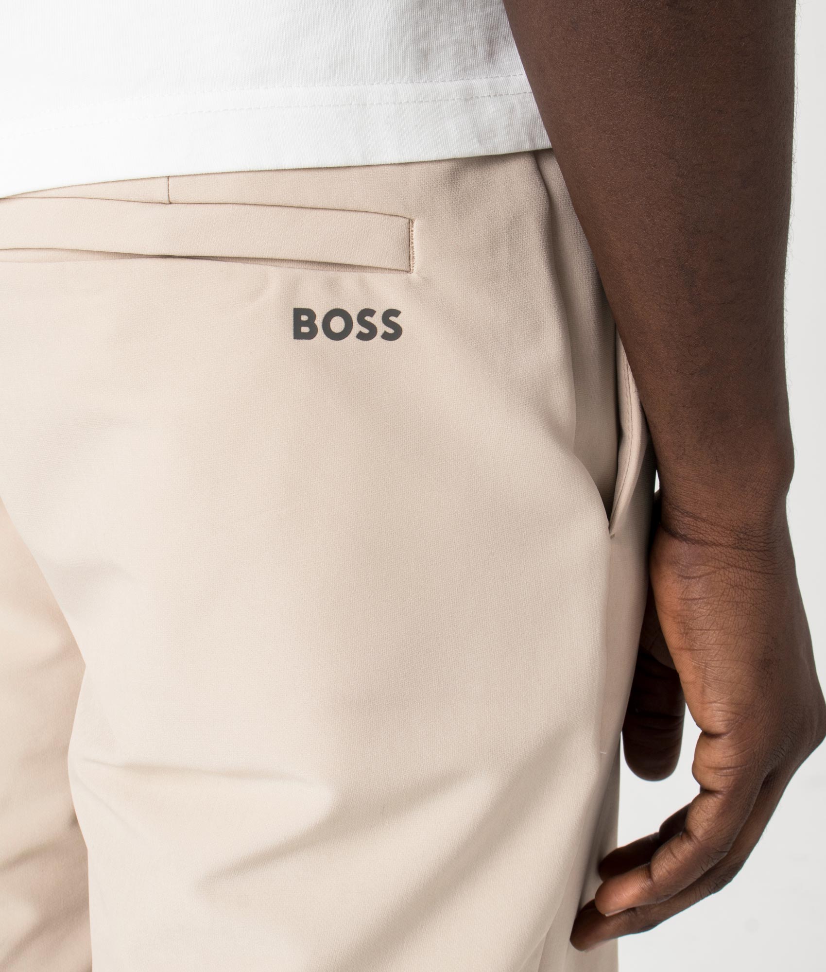 BOSS Slim Fit Commuter Chinos in Medium beige. Detail shot at EQVVS.