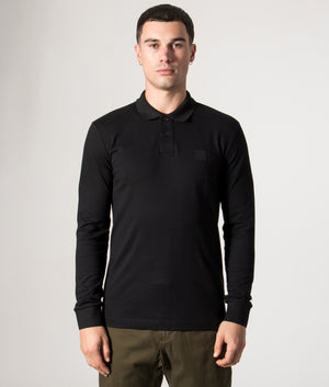 BOSS Slim Fit Passerby Long Sleeve Polo Shirt in black at EQVVS Menswear. Model front shot.