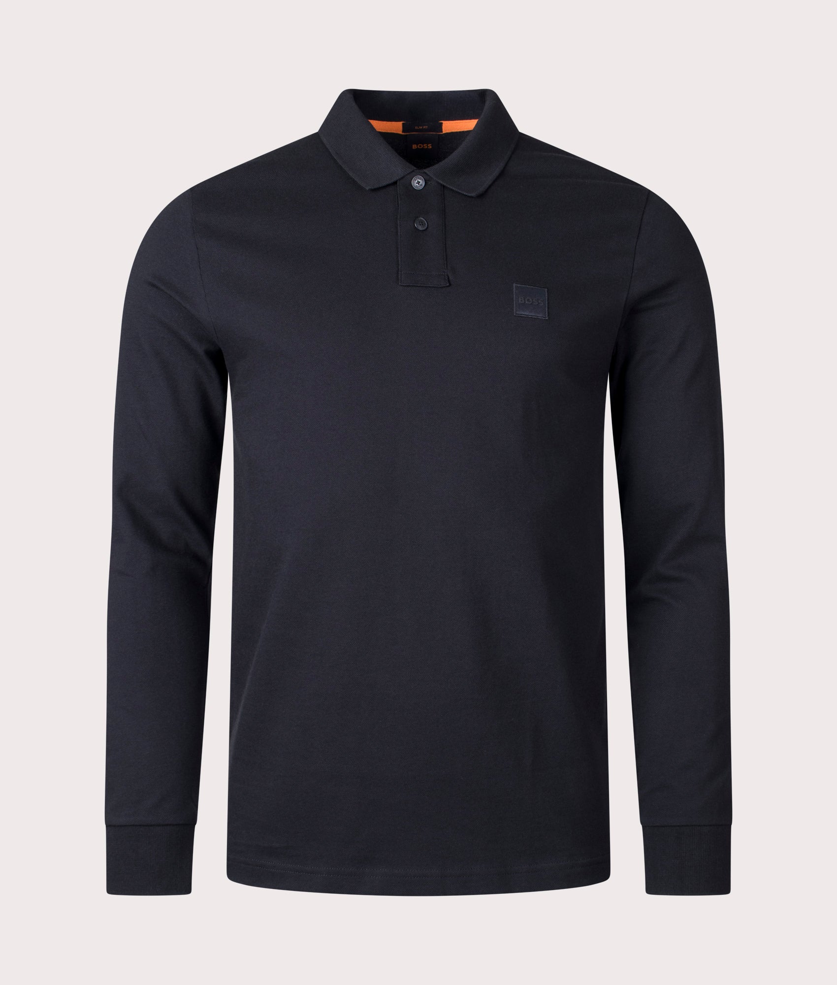 BOSS Slim Fit Passerby Long Sleeve Polo Shirt in black at EQVVS Menswear. Front shot.