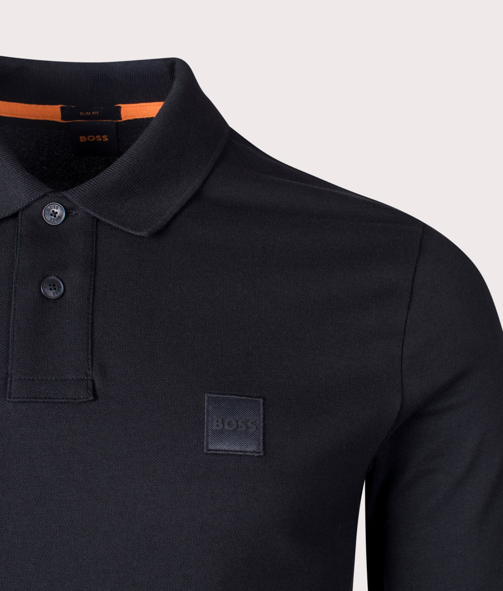 BOSS Slim Fit Passerby Long Sleeve Polo Shirt in black at EQVVS Menswear. Detail Shot.