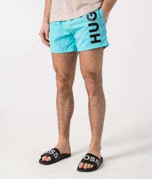 HUGO ABAS Lined Swim Shorts in Turquoise/Aqua. Side angle shot at EQVVS.