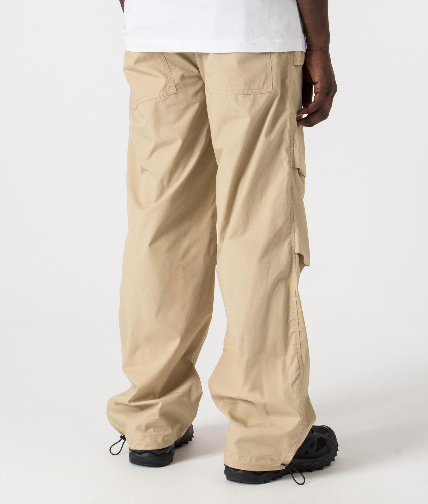 Genet242 Parachute Pants in Medium Beige by HUGO. EQVVS Back Angle Shot.