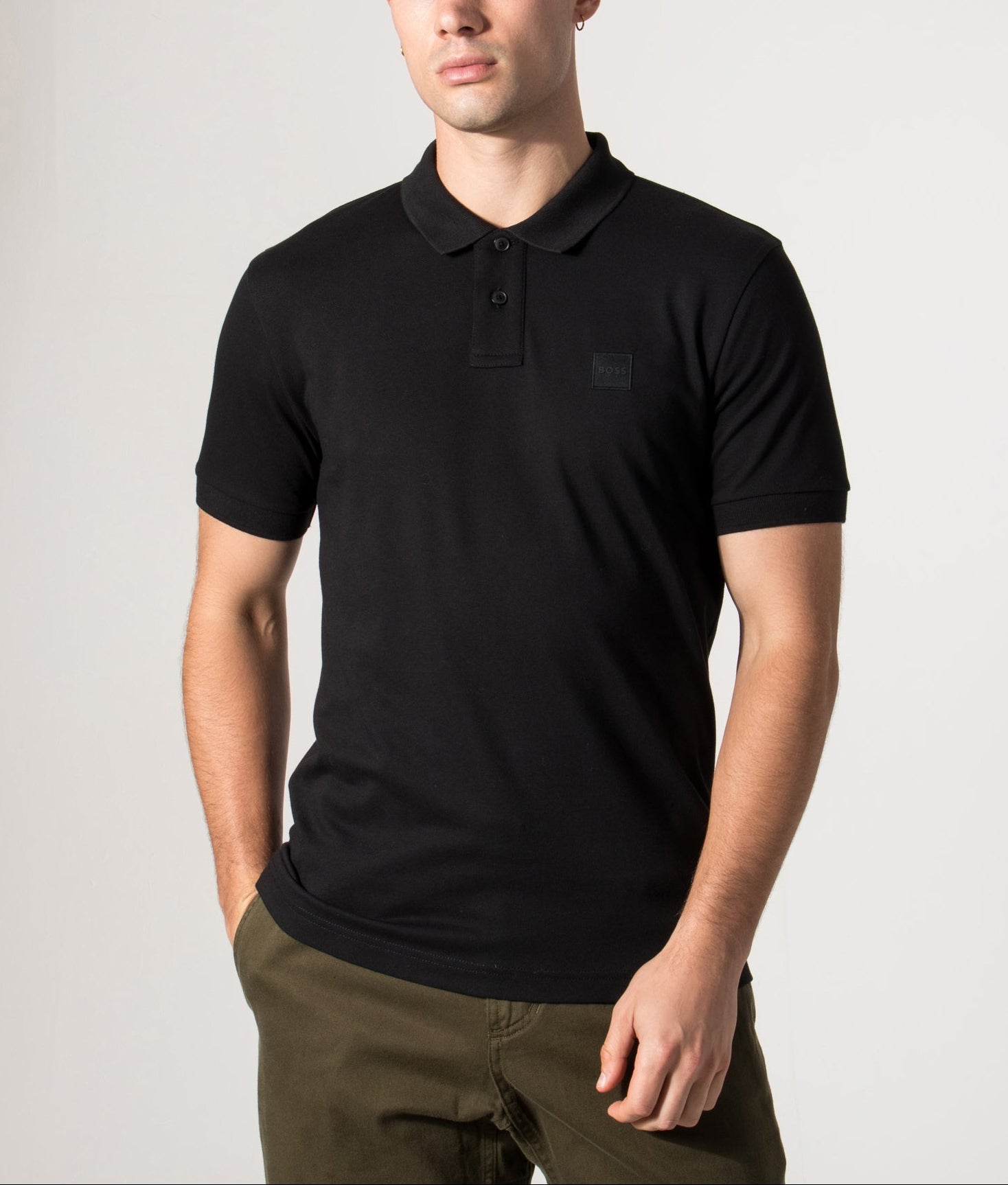 Boss Slim fit Passenger Polo Shirt in Black at EQVVS Menswear. Model front Shot.