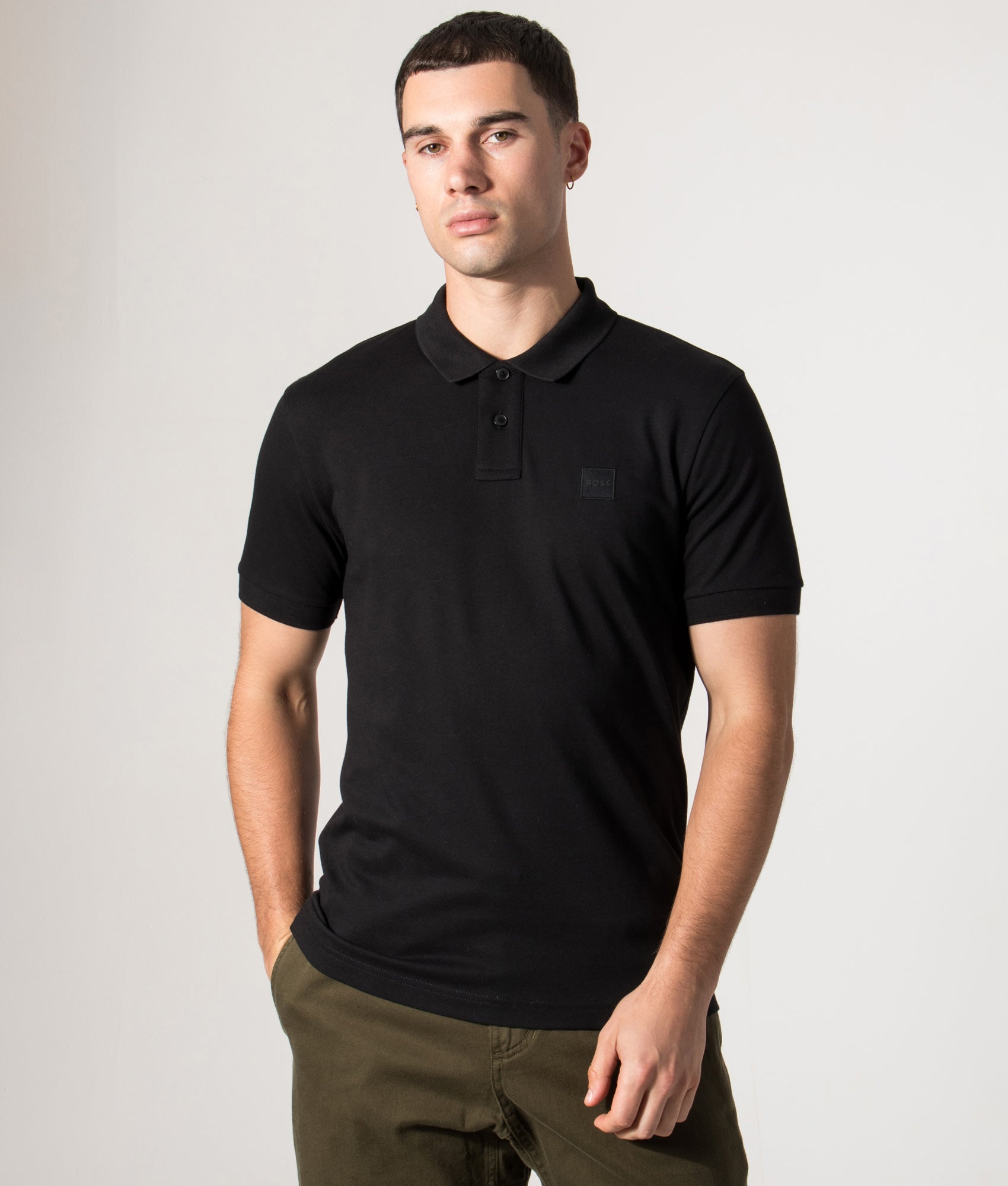 Boss Slim fit Passenger Polo Shirt in Black at EQVVS Menswear. Model front Shot.