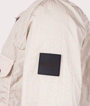 Boss orange Lovel Zip Through Overshirt in 271 light beige with arm branding side detail shot at EQVVS