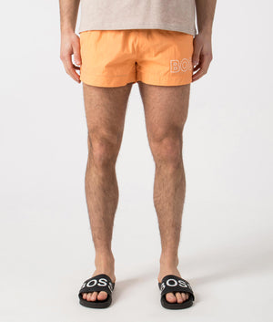 BOSS Mooneye Swim Shorts in Medium Orange. Front angle shot at EQVVS.