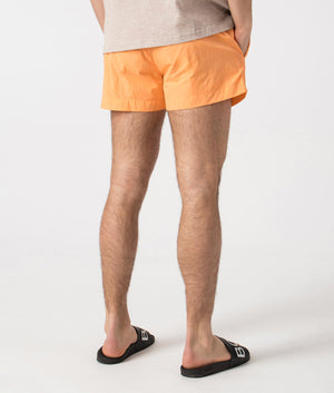 BOSS Mooneye Swim Shorts in Medium Orange. Back angle shot at EQVVS.