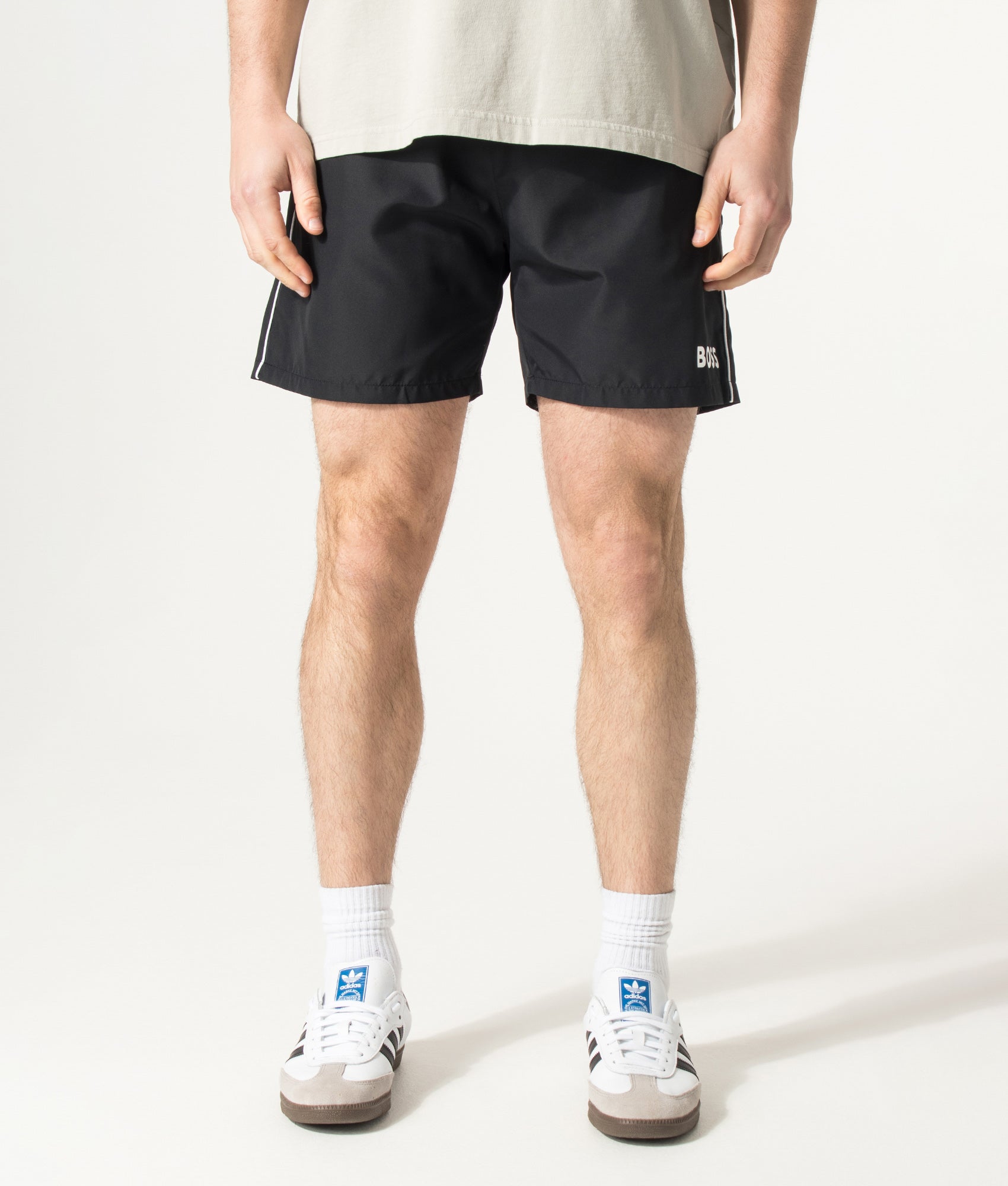 BOSS Starfish Swim Shorts in Black at EQVVS Menswear. Model front shot.