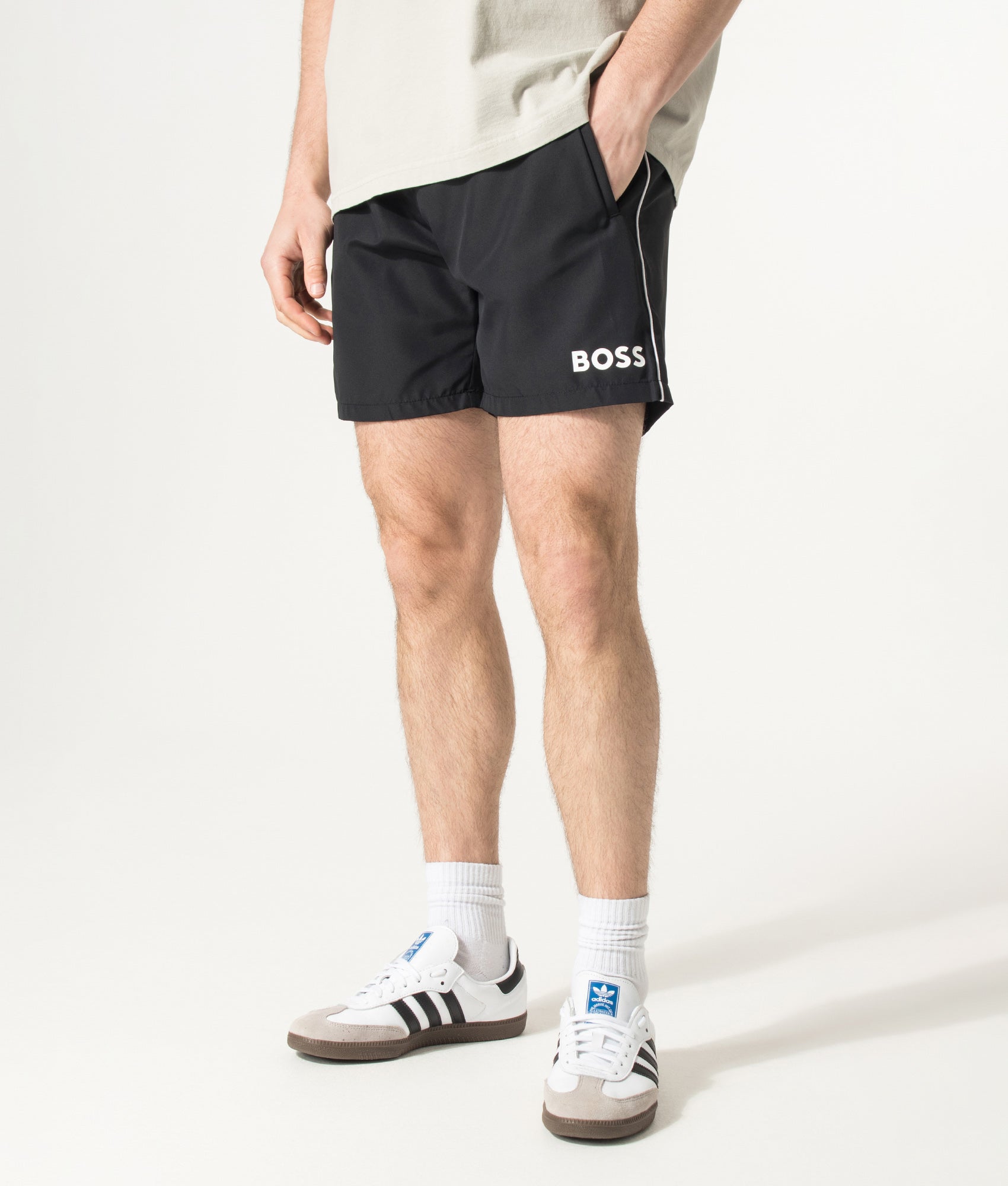 BOSS Starfish Swim Shorts in Black at EQVVS Menswear. Model front shot.