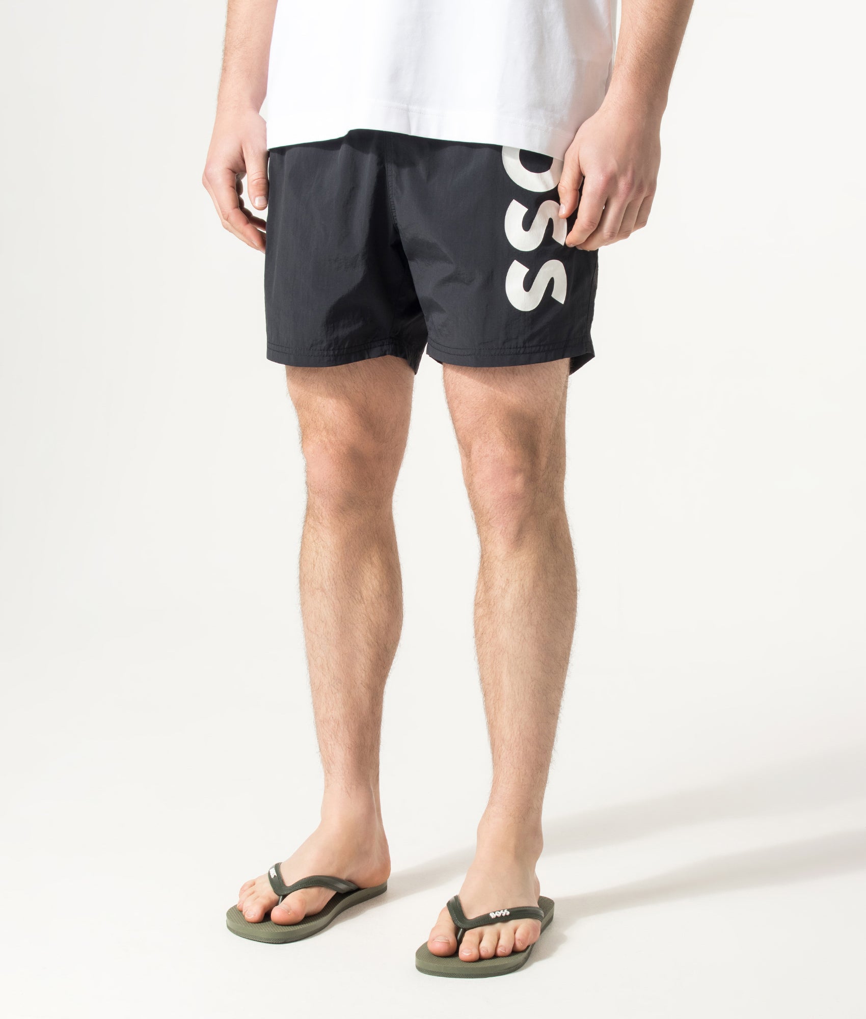 BOSS Octopus Swim Shorts in Black at EQVVS Menswear. Angled model front shot.