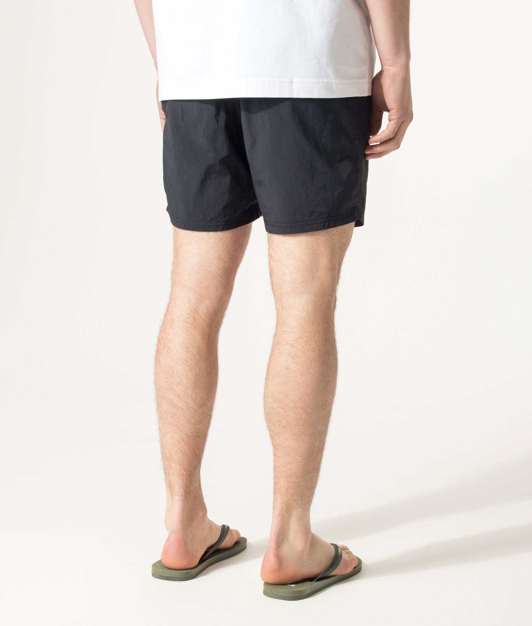 BOSS Octopus Swim Shorts in Black at EQVVS Menswear. Angled model back shot.