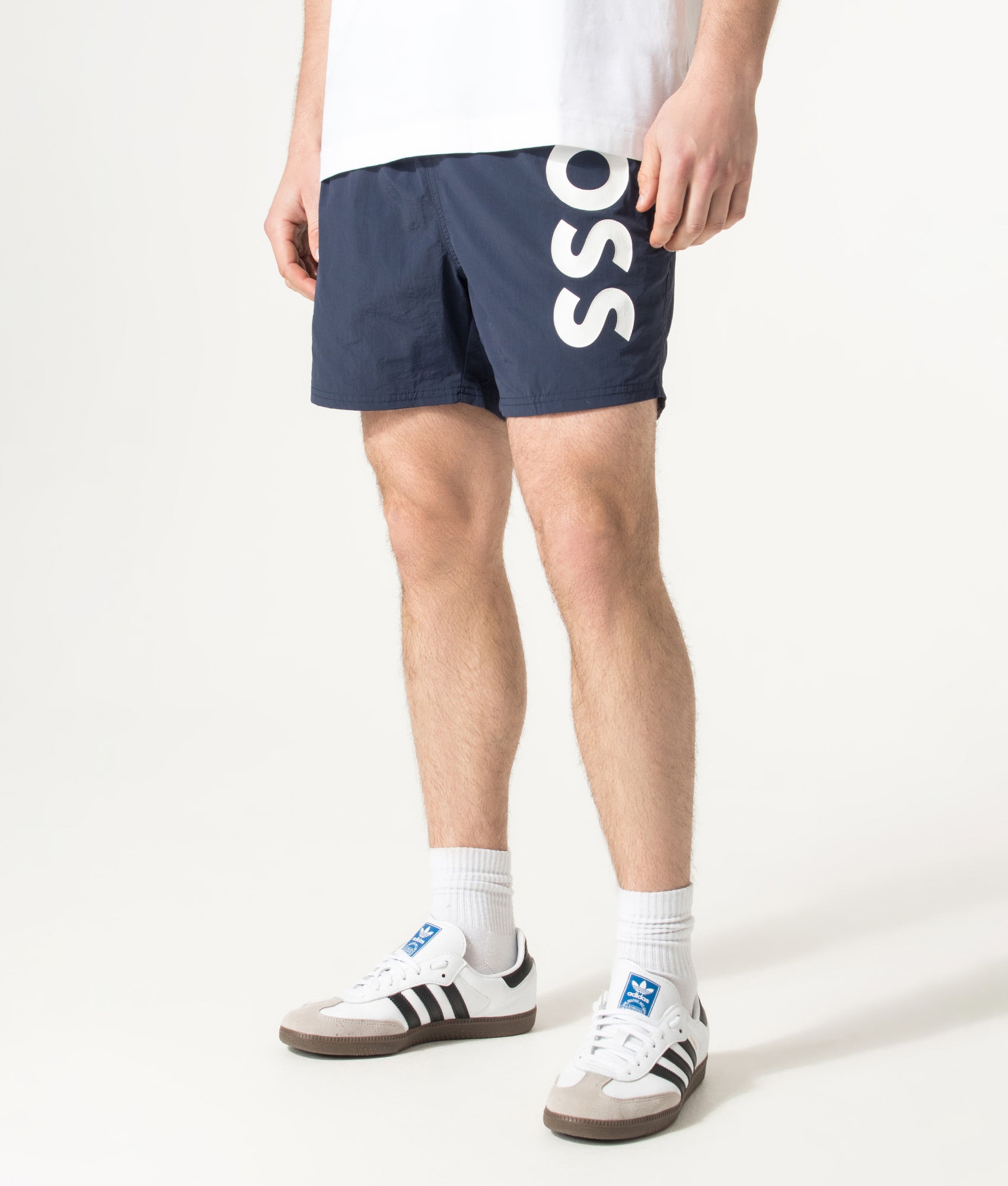 BOSS Octopus Swim Shorts in Navy at EQVVS Menswear. Angled model front shot.