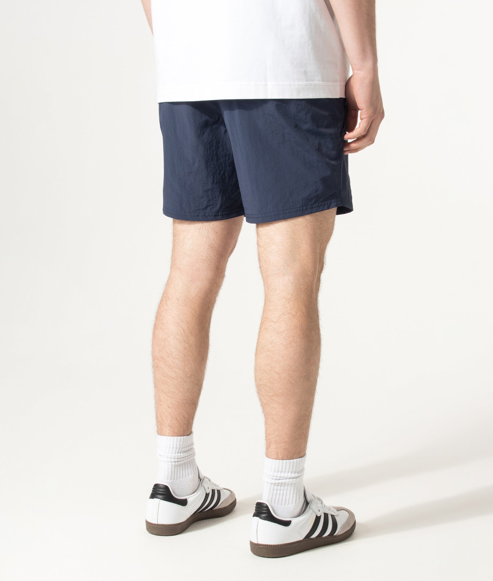 BOSS Octopus Swim Shorts in Navy at EQVVS Menswear. Angled model back shot.