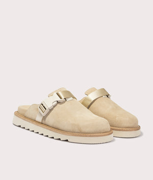 Syrax Slon Suede Mules in Light Beige. Front side angle shot at EQVVS.