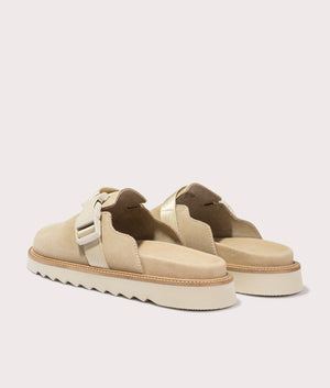 Syrax Slon Suede Mules in Light Beige. Back angle shot at EQVVS.