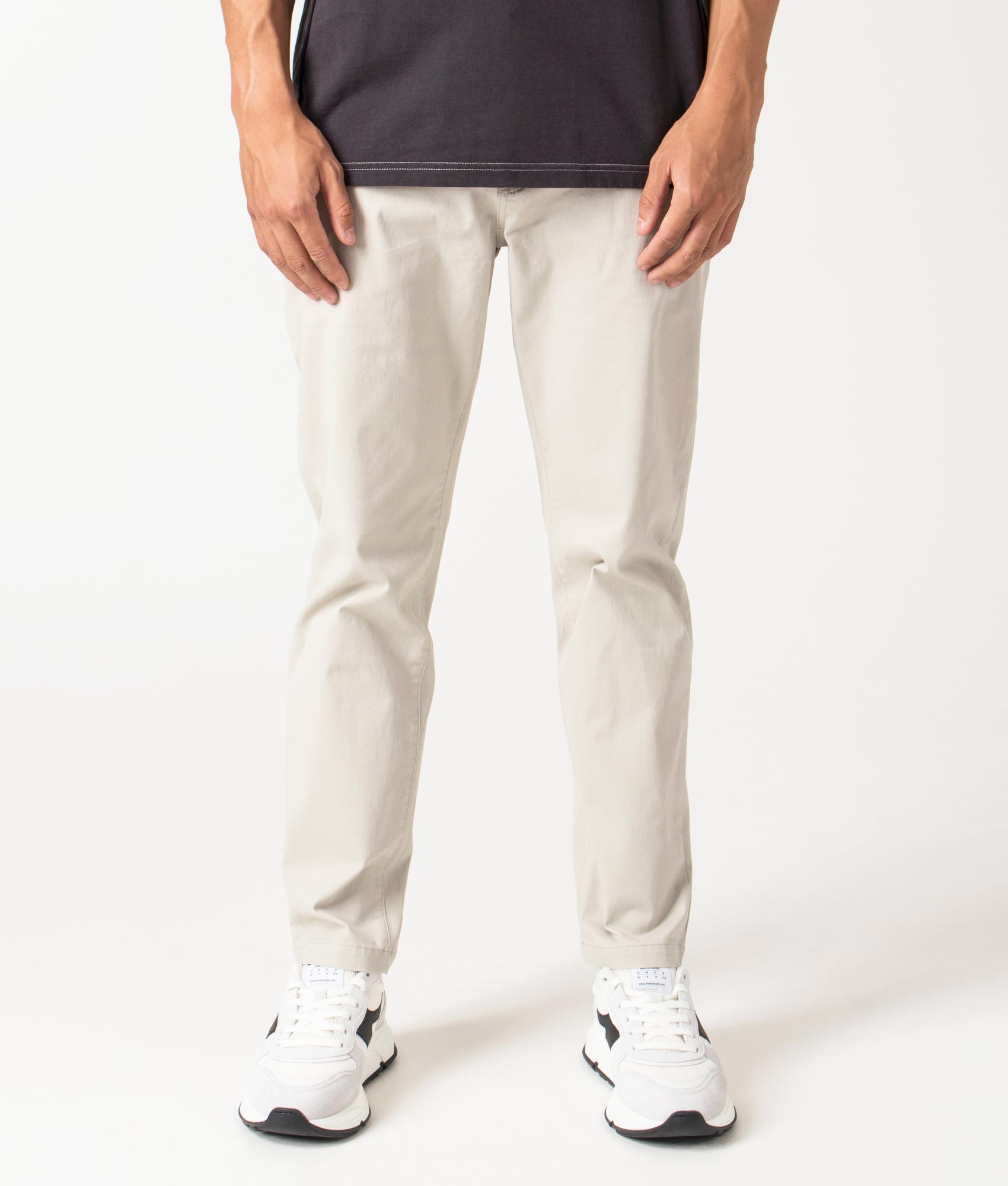 Chino Tapered Pants in light beige by BOSS. Shot at EQVVS. Front shot. 
