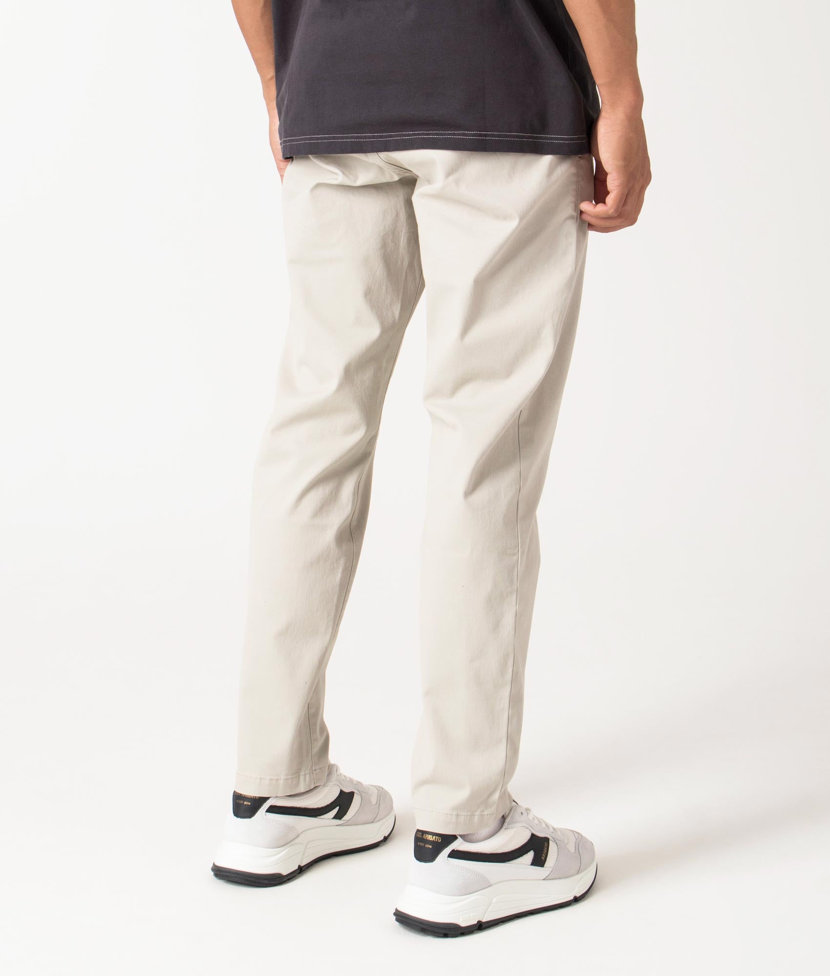 Chino Tapered Pants in light beige by BOSS. Shot at EQVVS. Reverse shot. 