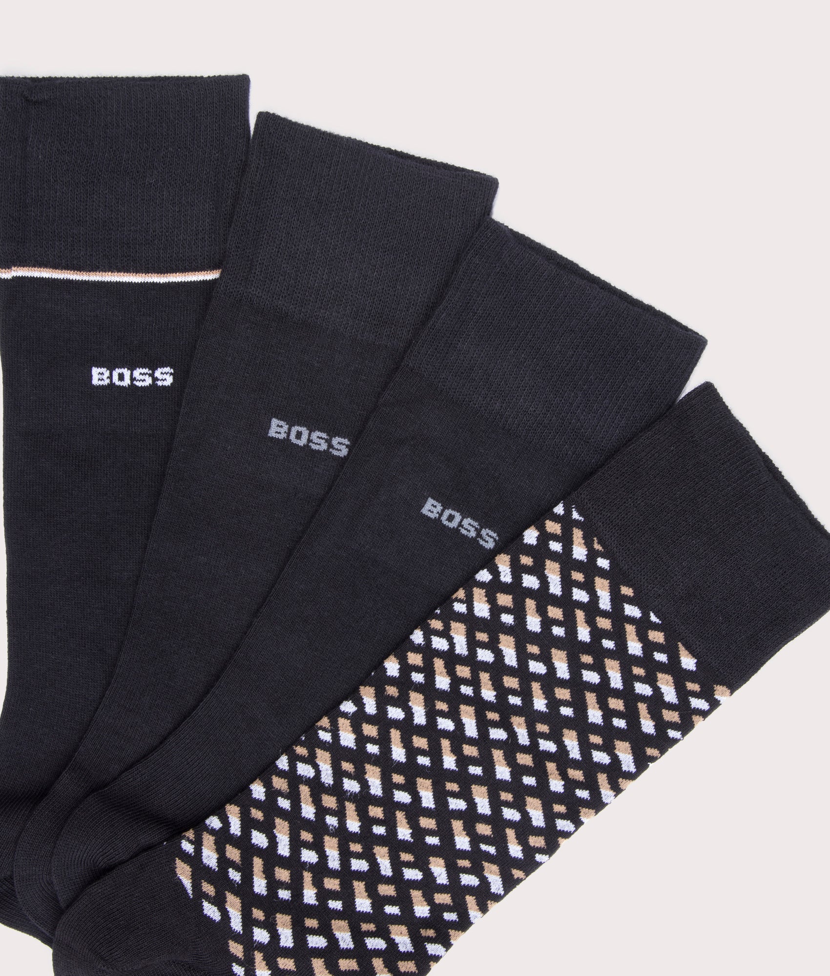 BOSS 4 Pack RS Monogrammed Socks in Black with Beige and White details at EQVVS Menswear. Front shot.