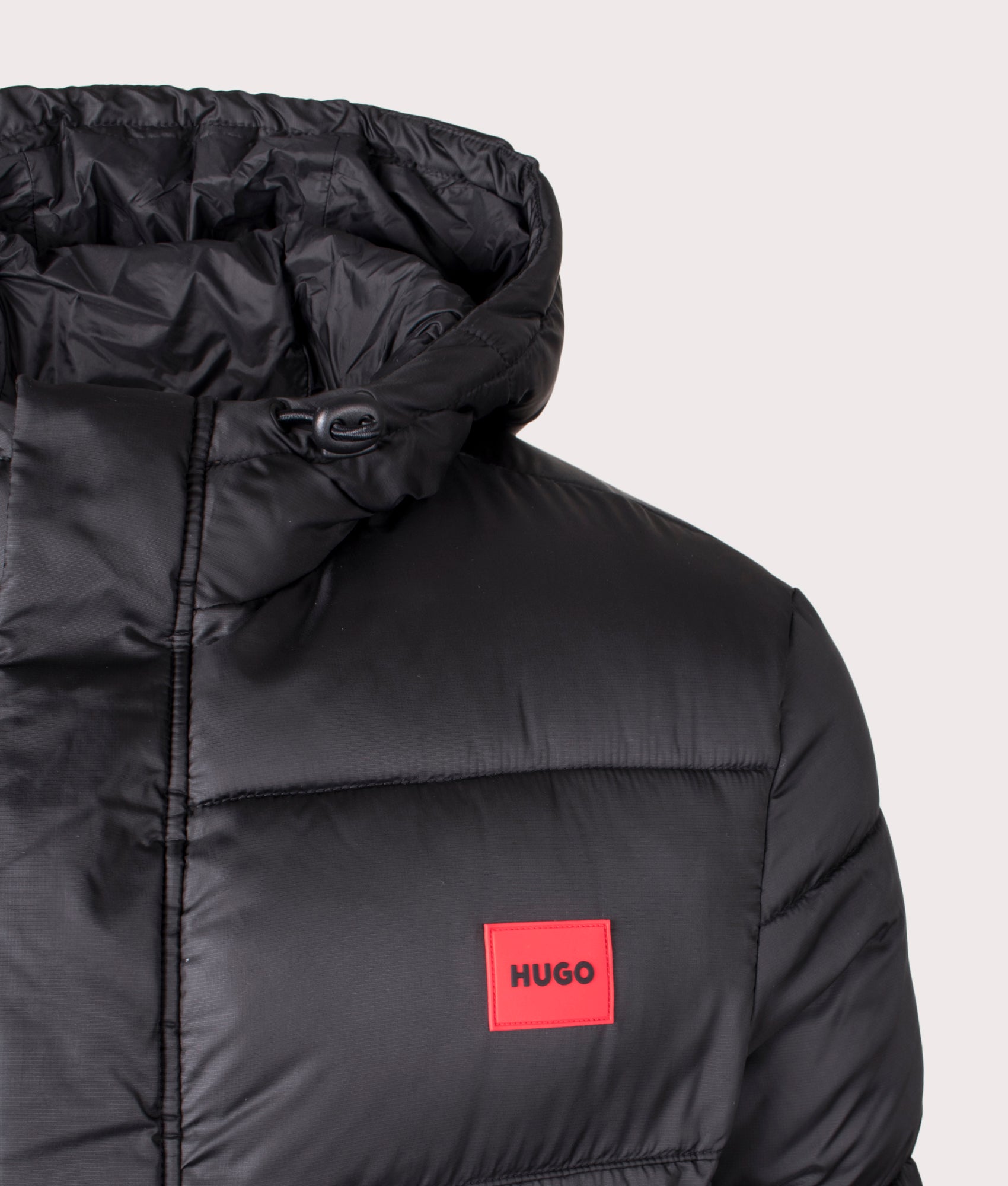 Black Baro2441 Puffer Coat by HUGO. Shot at EQVVS. Detail shot. 
