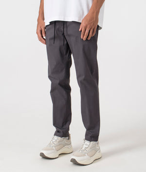 BOSS Chino Tapered Pants in Grey. Shot at EQVVS. Angle shot. 
