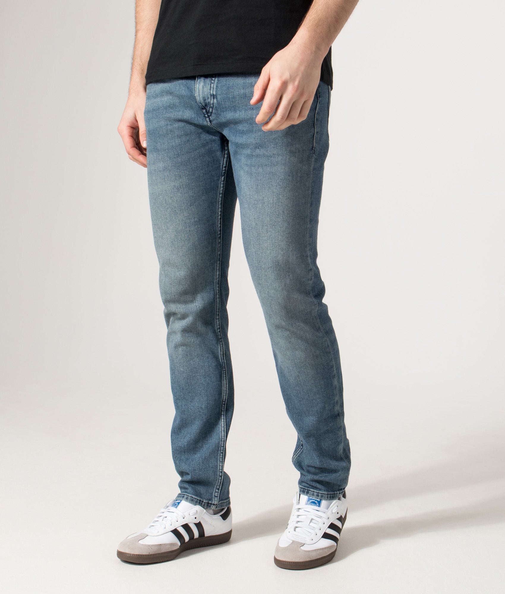 BOSS Slim Fit Delaware Jeans in Medium Blue | EQVVS | Front angle model shot 