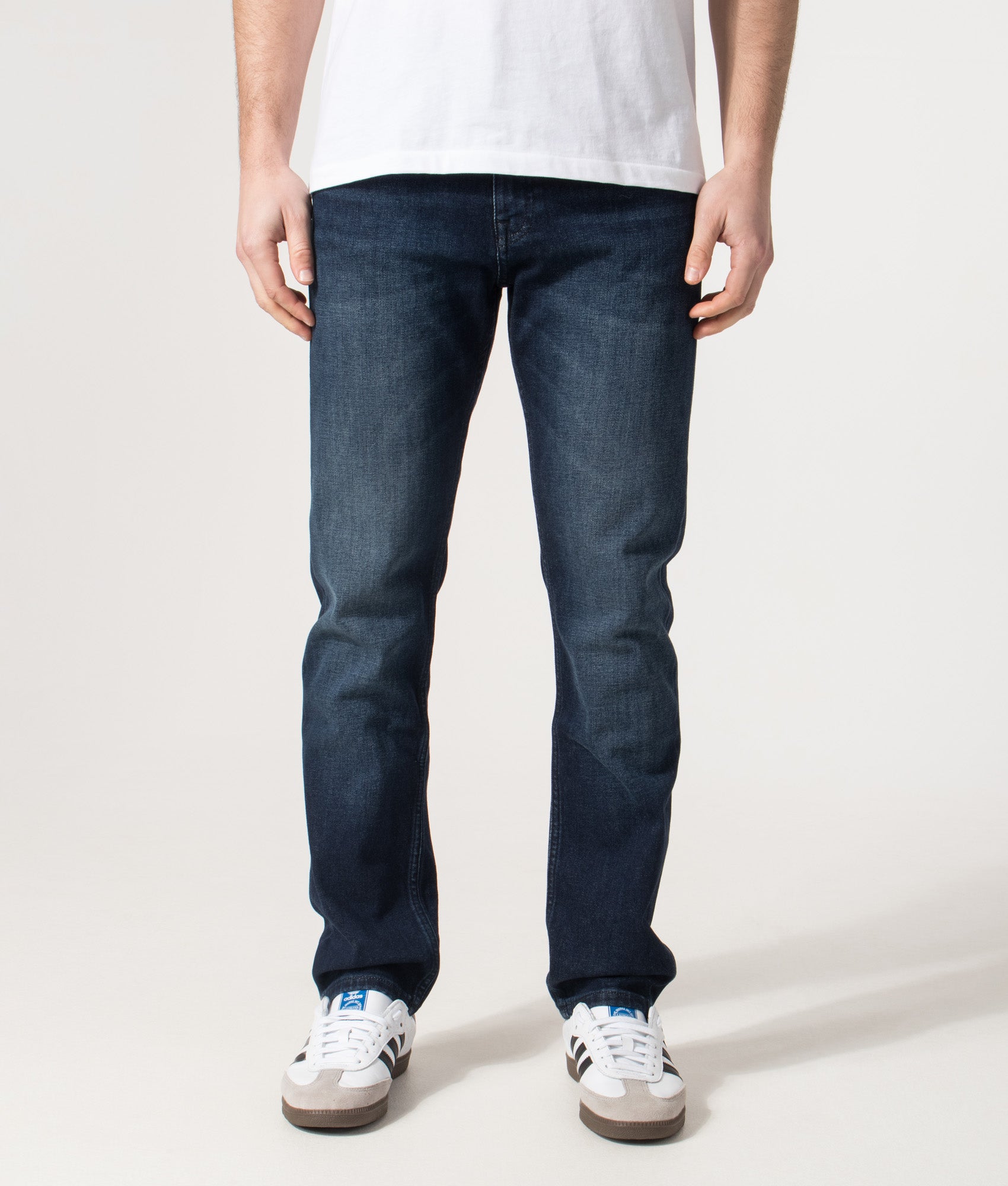 BOSS Slim Fit Delaware Jeans in the Dark Blue at EQVVS Menswear. Model front shot.