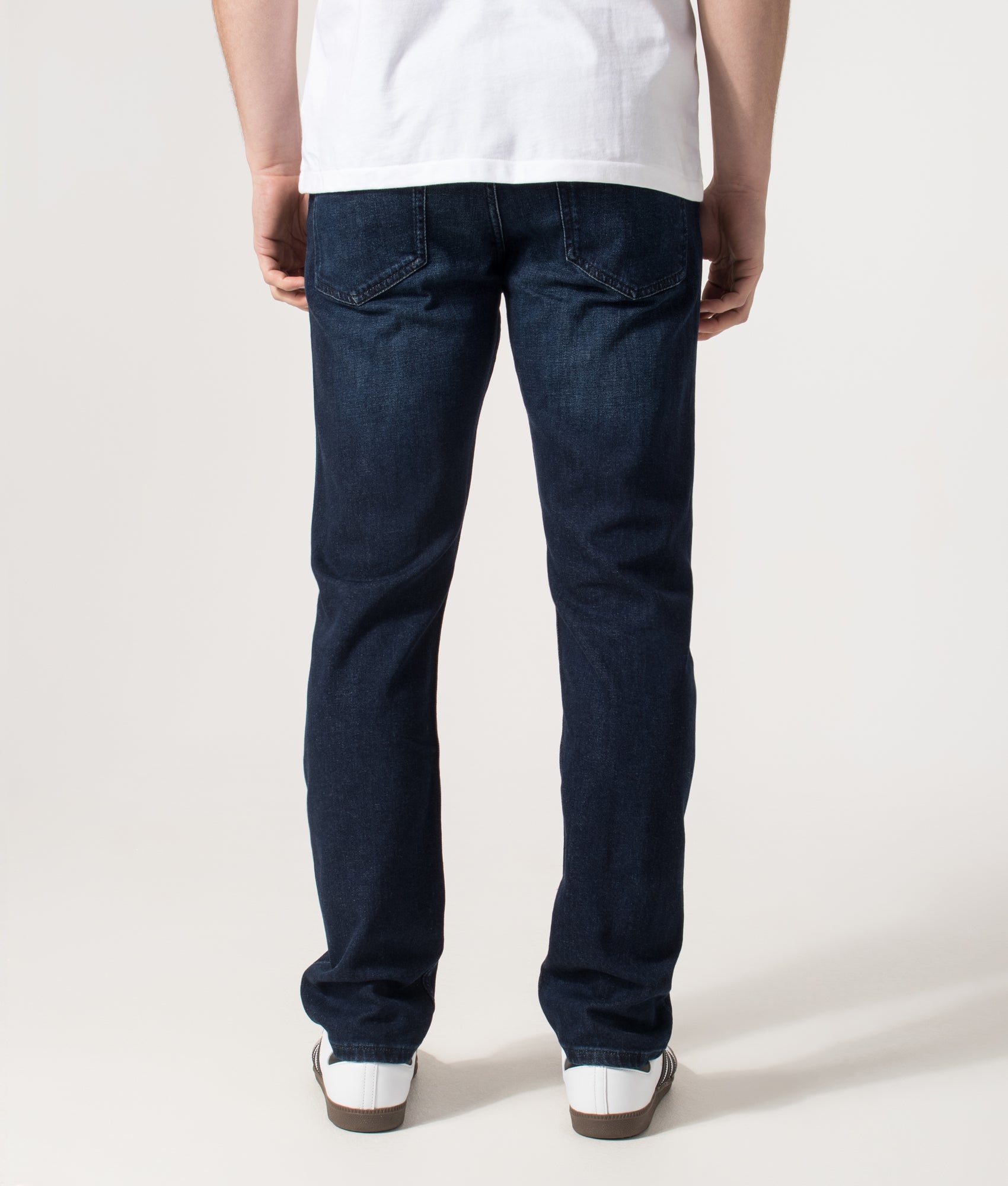BOSS Slim Fit Delaware Jeans in the Dark Blue at EQVVS Menswear. Model back shot.