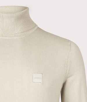BOSS Akiro Rollneck Jumper in Light Beige, Cotton/Cashmere Blend. At EQVVS Menswear. Front logo shot