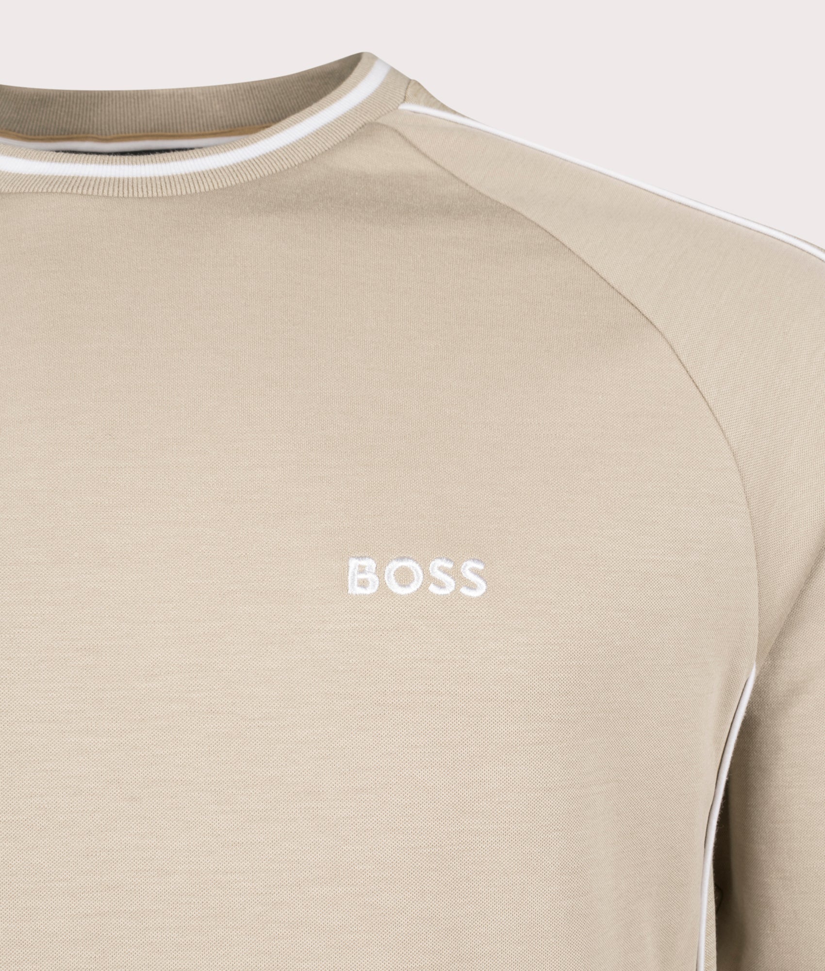 BOSS Track Top Sweatshirt in Light Beige. Shot at EQVVS. Front logo shot 